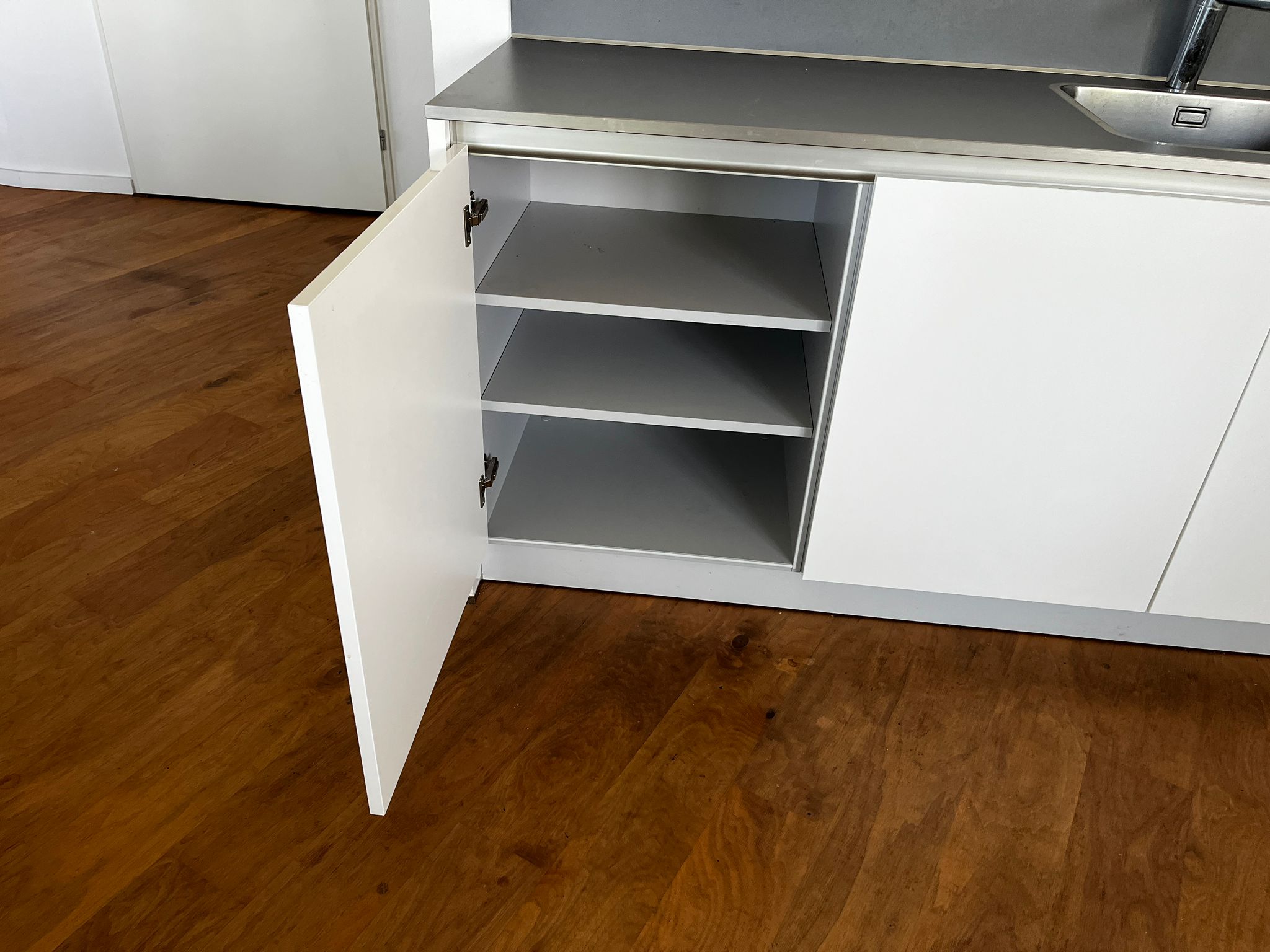 Witte hoekkeuken met ingebouwde AEG apparatuur kastje linksonder